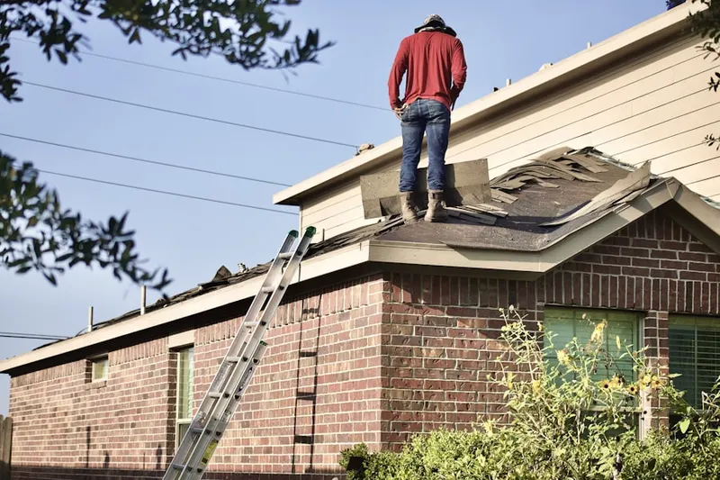 Professional roofer working on a residential roof in Hartford